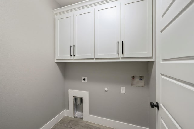 laundry area featuring hardwood / wood-style floors, hookup for a washing machine, cabinets, hookup for a gas dryer, and hookup for an electric dryer