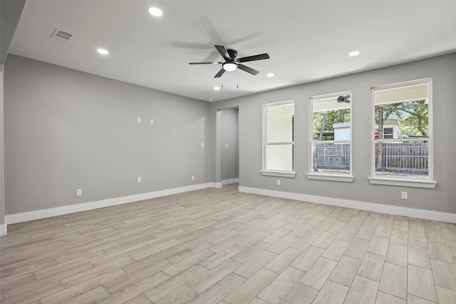 empty room with ceiling fan and light wood-type flooring