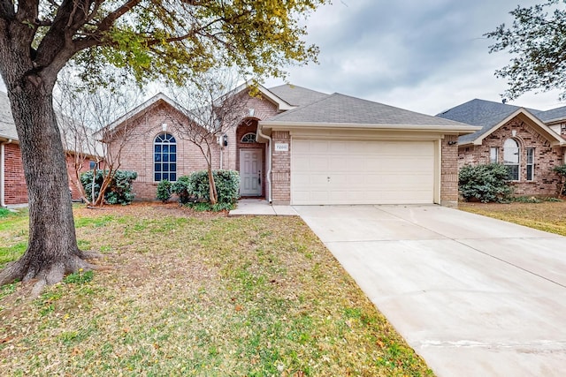 ranch-style home featuring a garage and a front lawn