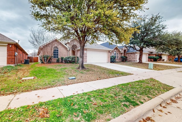 ranch-style home with a garage, central AC, and a front yard