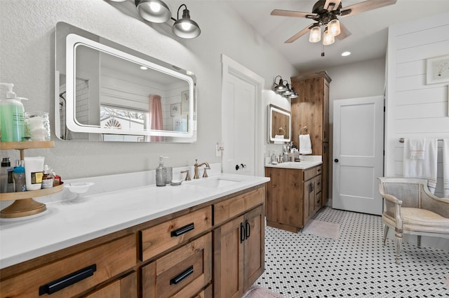 full bath with tile patterned floors, vanity, and a ceiling fan