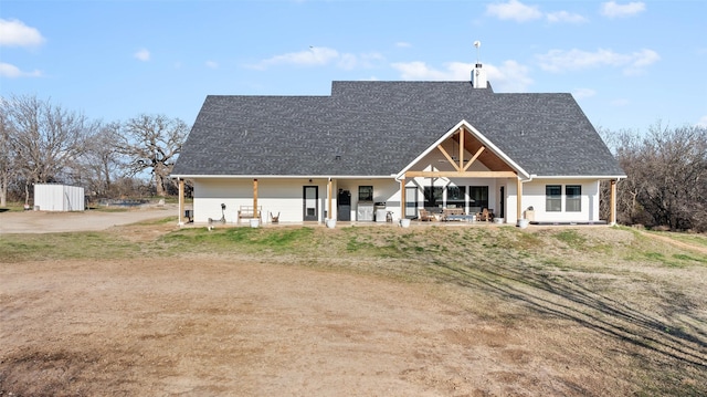 view of front facade featuring a shed and a chimney