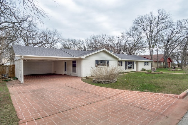 ranch-style house with a garage and a front lawn