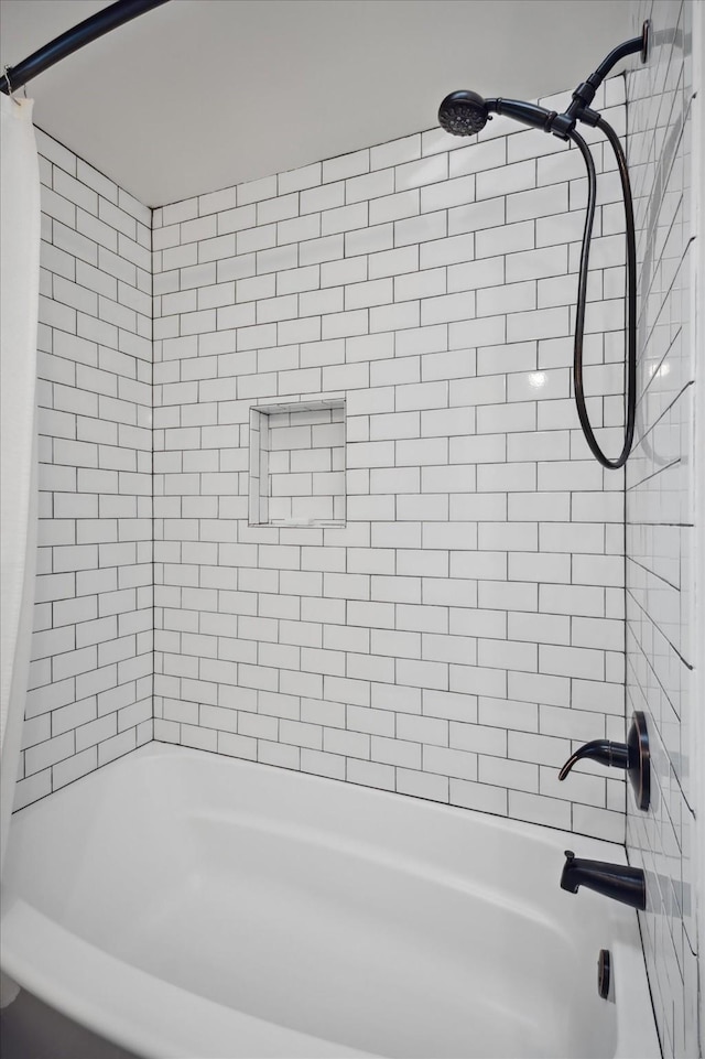 bathroom with shower / bath combination with curtain