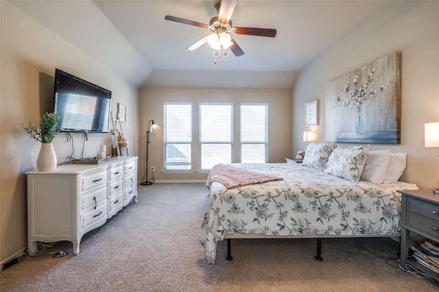 bedroom with baseboards, vaulted ceiling, a ceiling fan, and light colored carpet