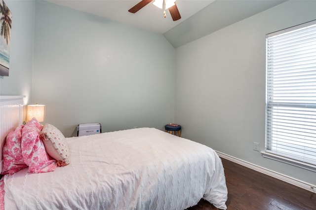 bedroom with lofted ceiling, ceiling fan, dark wood-style floors, and baseboards