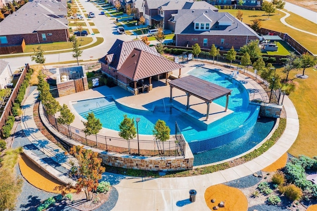 view of swimming pool with a residential view and fence