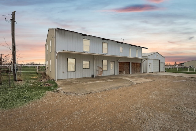 view of front of property featuring a garage and an outdoor structure