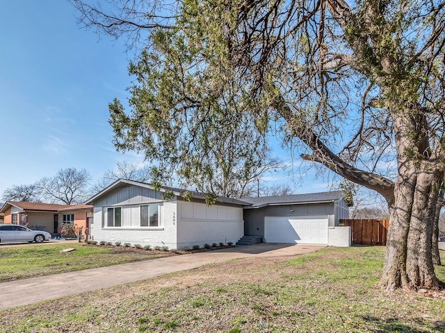 ranch-style home featuring a garage and a front lawn