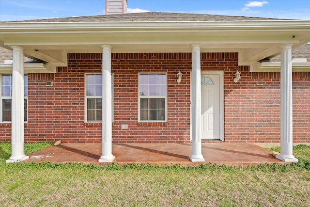 doorway to property with a lawn