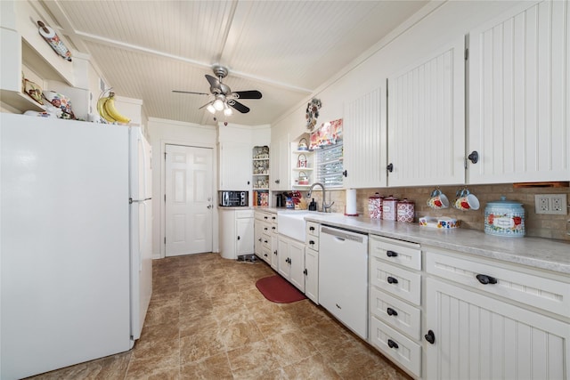 kitchen with white appliances, light countertops, a sink, and white cabinets