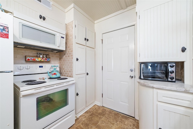 kitchen featuring tasteful backsplash, white appliances, visible vents, and white cabinetry