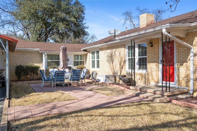 ranch-style home with a carport, aphalt driveway, and brick siding