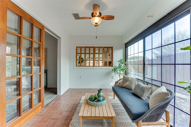 sunroom featuring ceiling fan