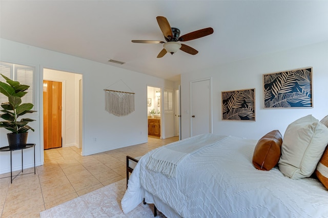 bedroom featuring connected bathroom, ceiling fan, and light tile patterned flooring