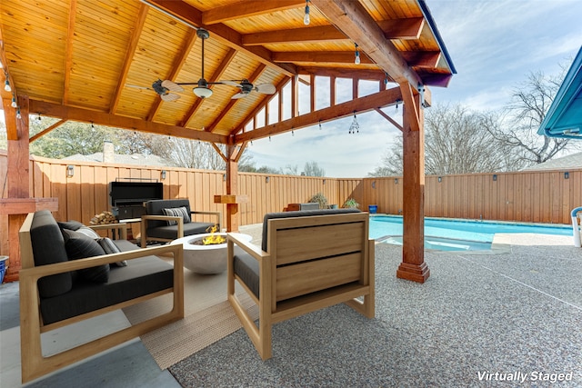 view of patio featuring a fenced in pool, a gazebo, an outdoor hangout area, and ceiling fan