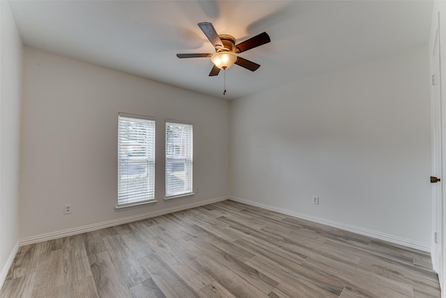 spare room featuring ceiling fan and light hardwood / wood-style flooring