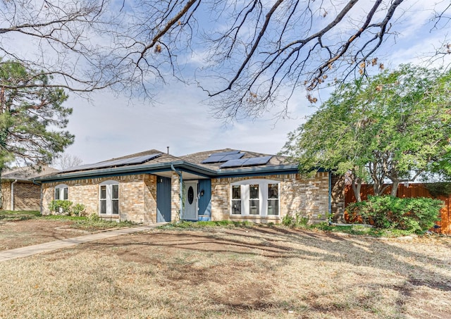 view of front of property with solar panels