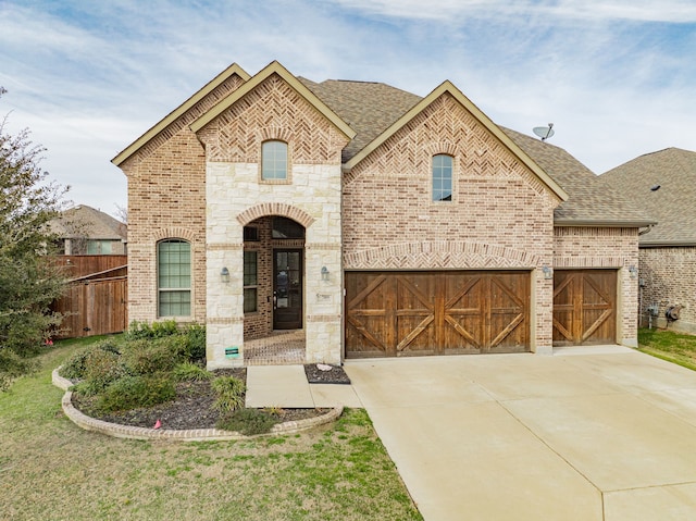 french country style house with a garage