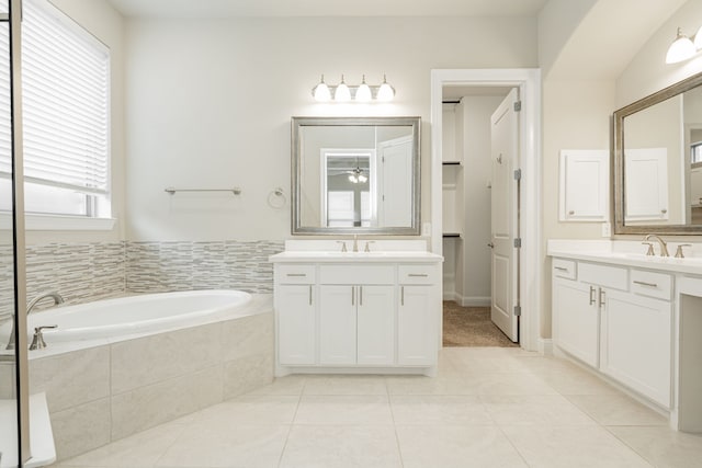 bathroom featuring vanity, tiled bath, and tile patterned floors