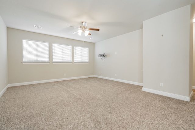 empty room with light carpet and ceiling fan