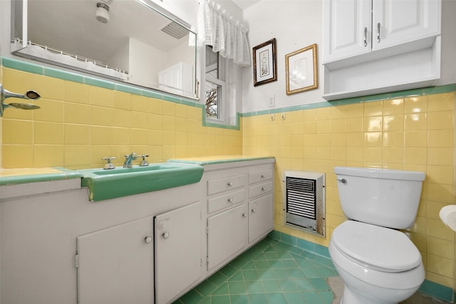 bathroom with heating unit, vanity, toilet, tile patterned floors, and a shower with shower curtain