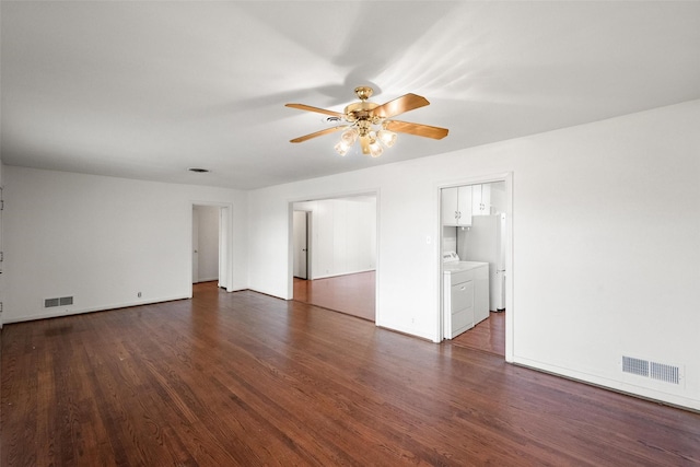 spare room with ceiling fan, dark hardwood / wood-style floors, and washer and dryer