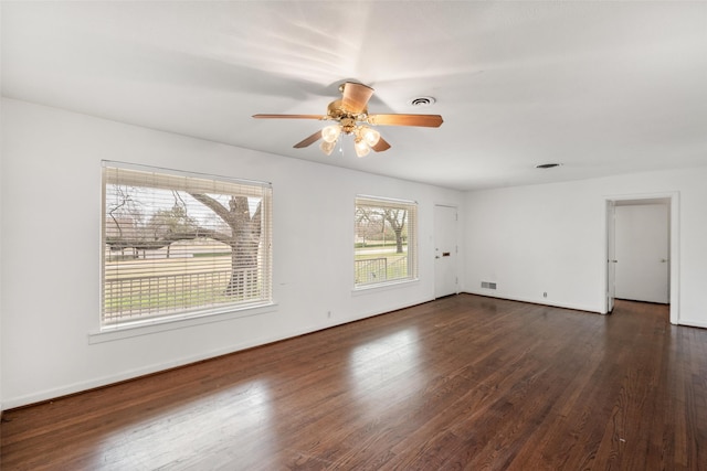 spare room featuring dark hardwood / wood-style flooring and ceiling fan