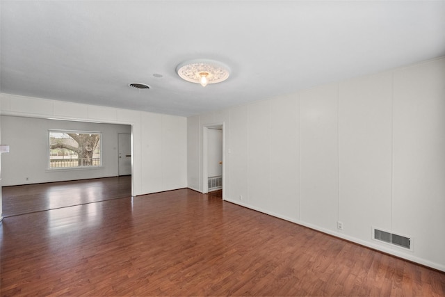 empty room featuring dark wood-type flooring