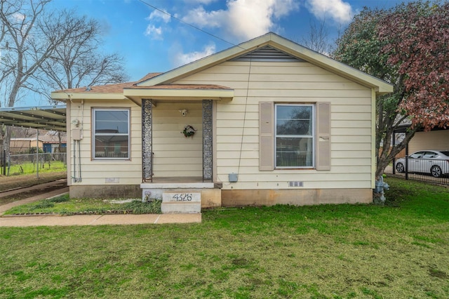 bungalow with a carport and a front lawn