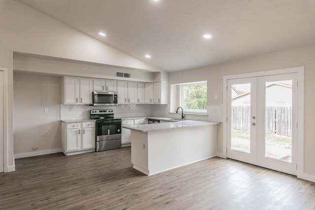 kitchen with french doors, kitchen peninsula, white cabinets, and appliances with stainless steel finishes