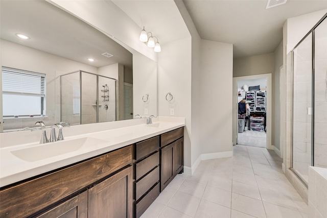 bathroom featuring tile patterned floors, vanity, and an enclosed shower