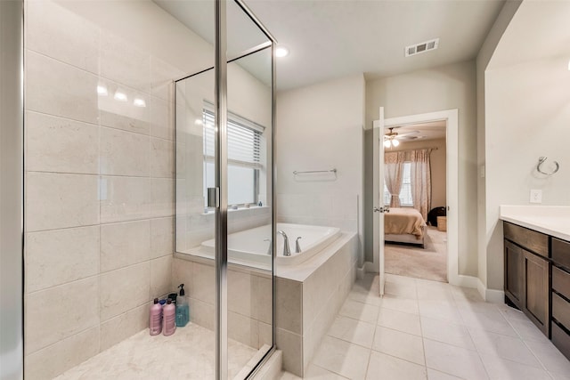 bathroom featuring vanity, shower with separate bathtub, and tile patterned floors