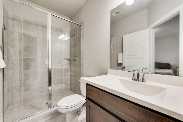 bathroom featuring vanity, an enclosed shower, and toilet