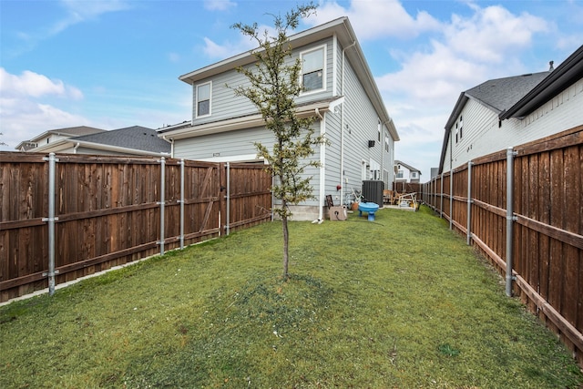 view of yard featuring a fenced backyard and central AC