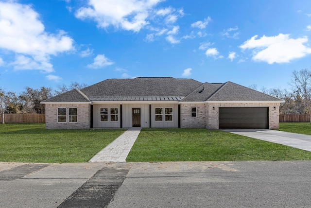 single story home with a garage and a front lawn