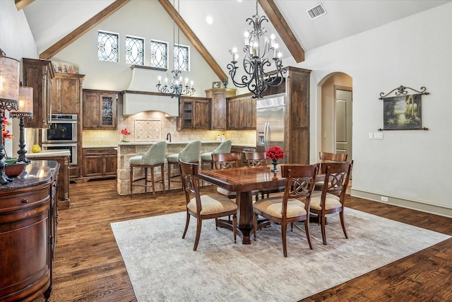 dining room with arched walkways, high vaulted ceiling, visible vents, beamed ceiling, and dark wood finished floors