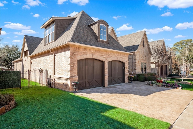 view of property exterior with an attached garage, brick siding, a shingled roof, a yard, and driveway