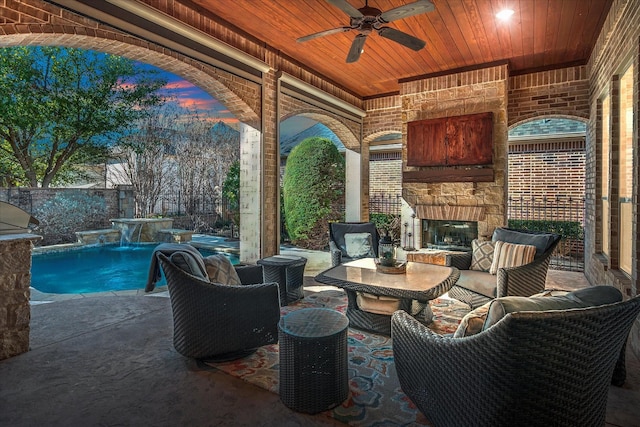 view of patio with an outdoor pool, an outdoor living space with a fireplace, a fenced backyard, and ceiling fan