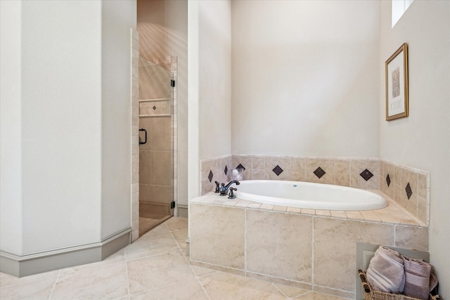 bathroom with a stall shower and a garden tub