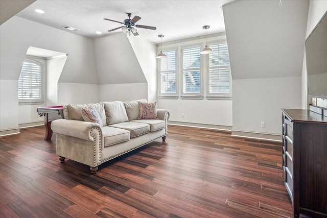 living area with lofted ceiling, dark wood-style floors, ceiling fan, and visible vents