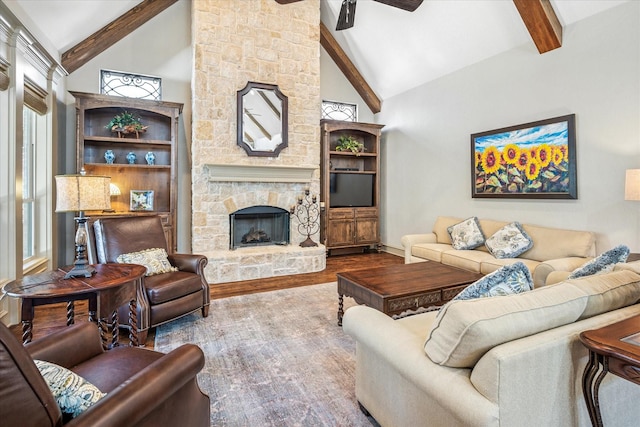 living room with high vaulted ceiling, a fireplace, wood finished floors, and beam ceiling