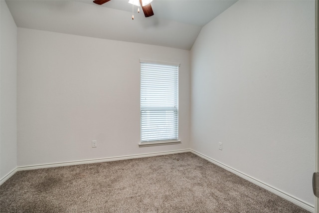 spare room featuring vaulted ceiling, ceiling fan, and carpet flooring