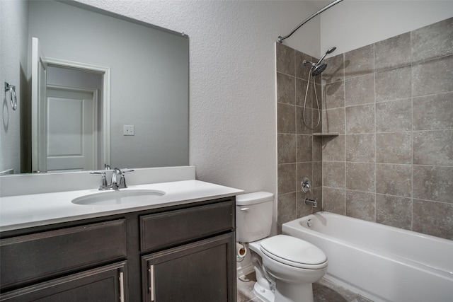 full bathroom with vanity, toilet, and tiled shower / bath