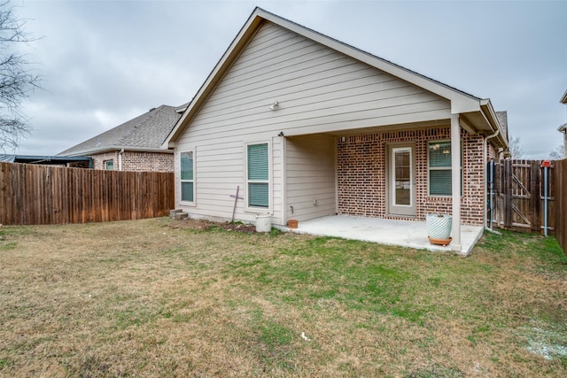 back of property with a patio and a yard