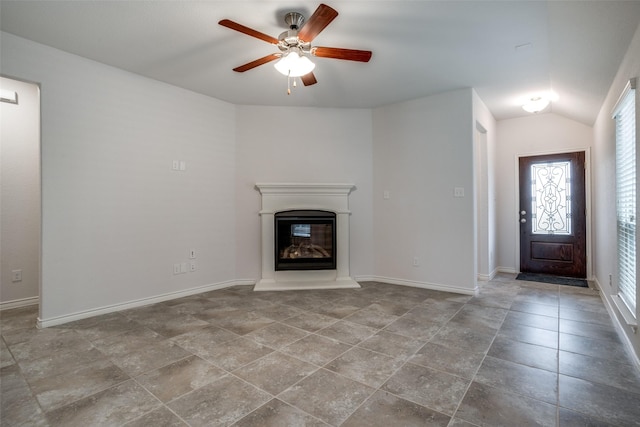 unfurnished living room featuring ceiling fan and vaulted ceiling