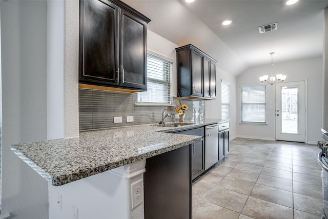 kitchen featuring tasteful backsplash, dishwasher, light stone countertops, and dark brown cabinetry