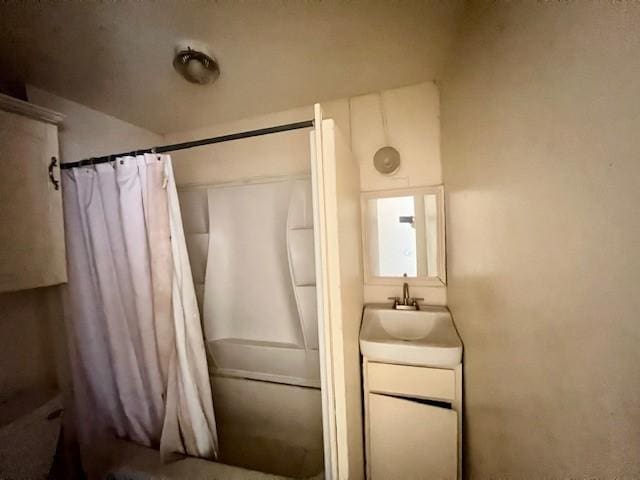 bathroom featuring vanity and shower / bathtub combination with curtain