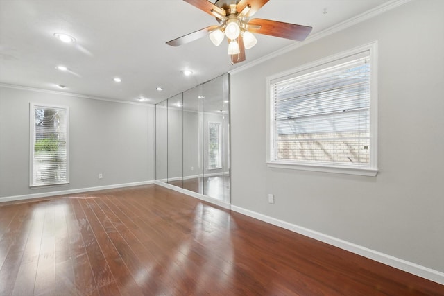 unfurnished room with a ceiling fan, crown molding, baseboards, and wood finished floors