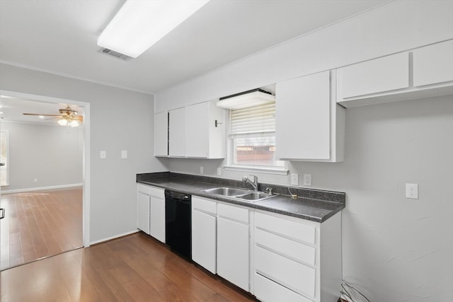 kitchen featuring black dishwasher, visible vents, dark countertops, dark wood-style flooring, and a sink